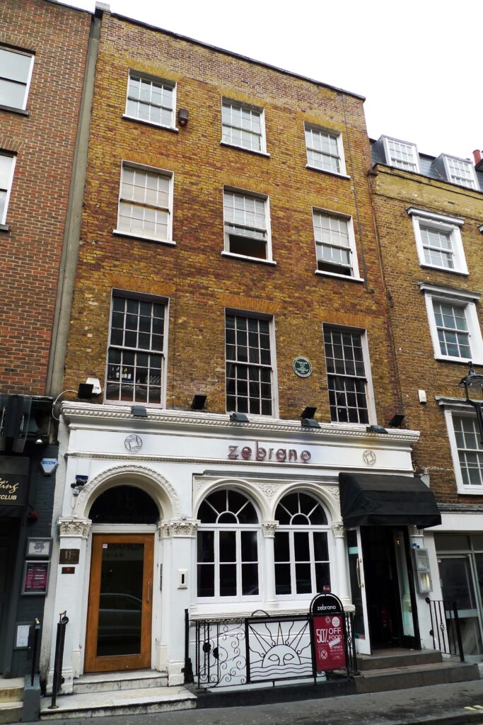 The Greek Street former location of The Establishment, with a green plaque commemorating it.